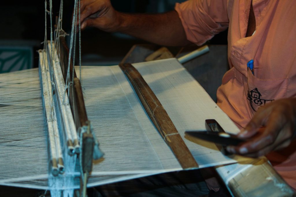 a man is working on a weaving machine